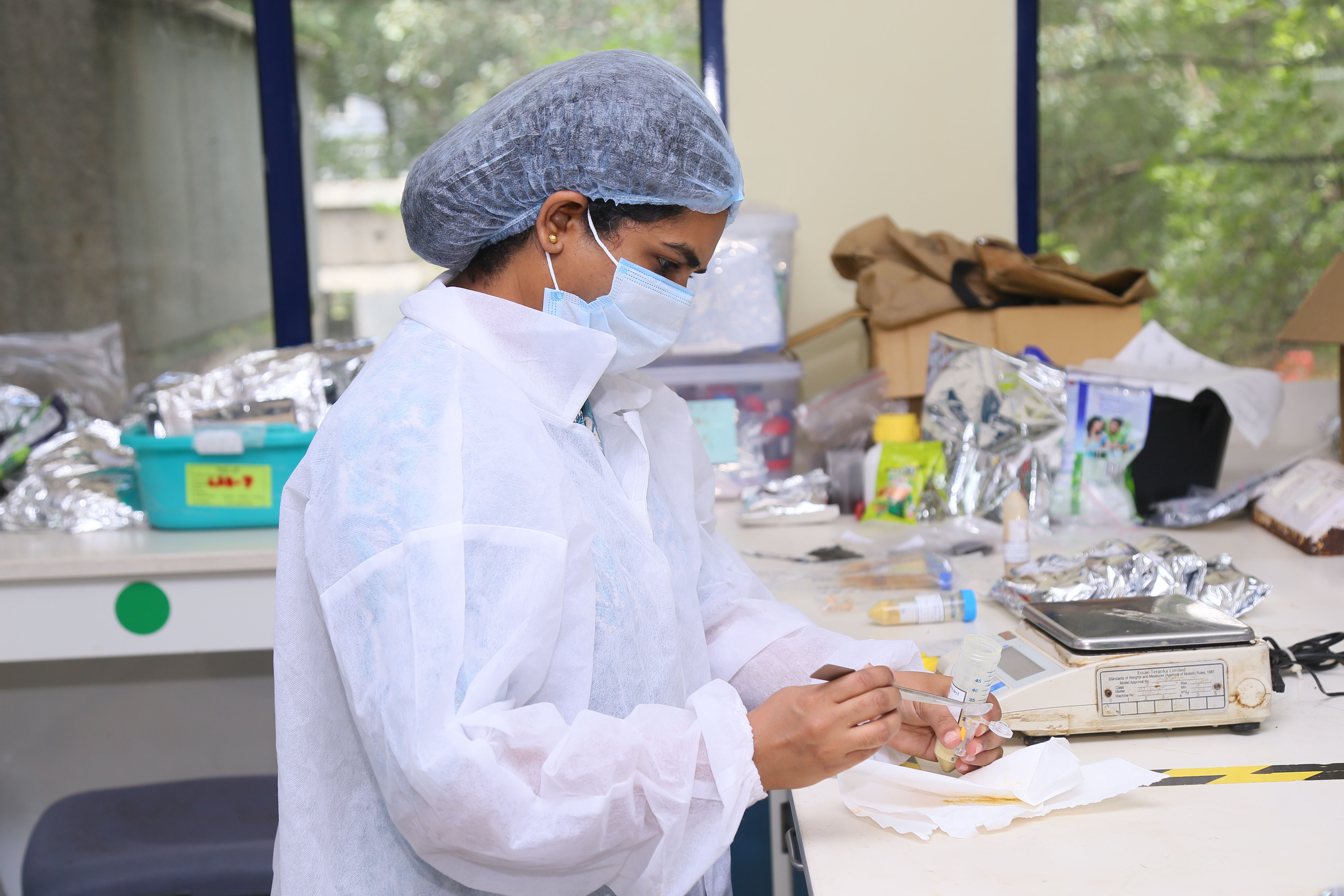 Image of a female HUL scientist working on testing a powder in a laboratory