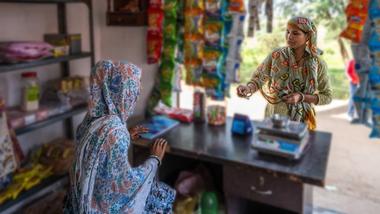 Woman buying snacks at a small rural shop