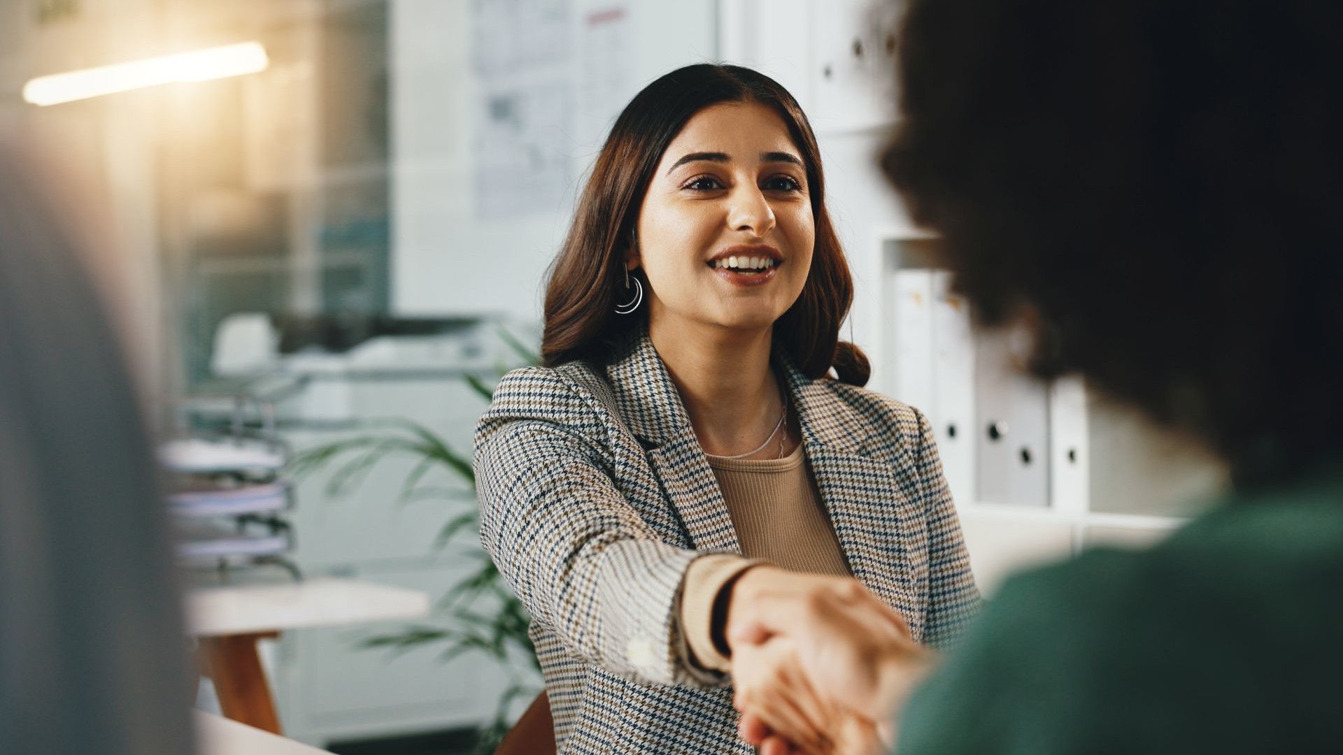 Two women handshake.