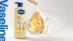 Vaseline Deep Moisture lotion bottle beside a golden serum droplet and clear bubbles.