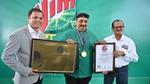 Three men holding an award.