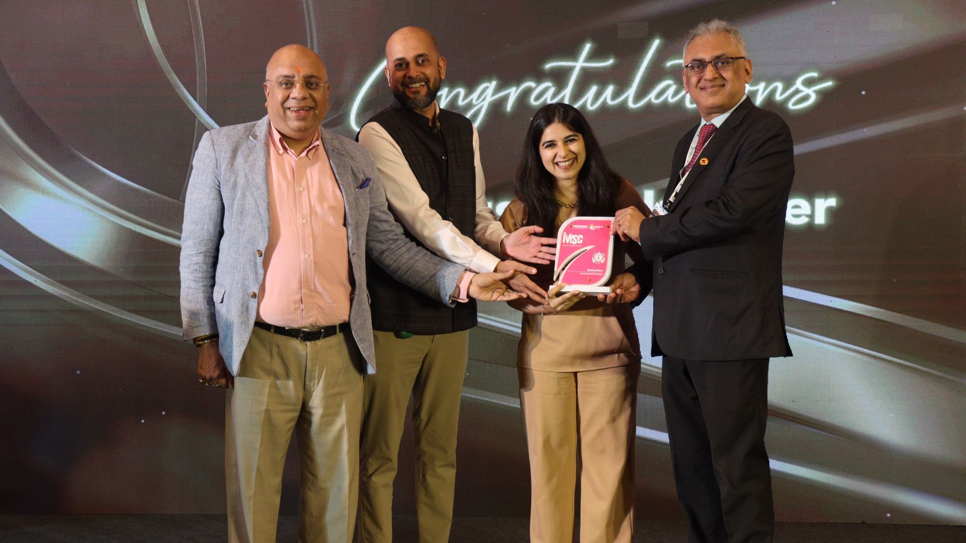 Four people with the IMSC award.