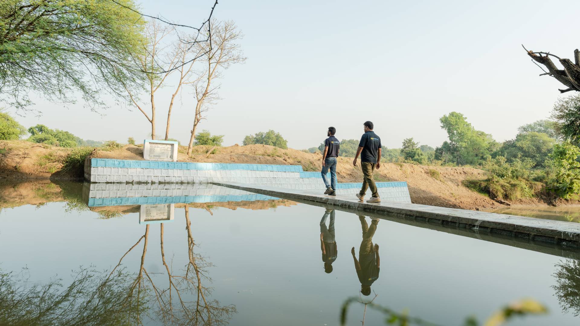 A group of Prabhat beneficiaries near a water body