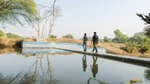 A group of Prabhat beneficiaries near a water body