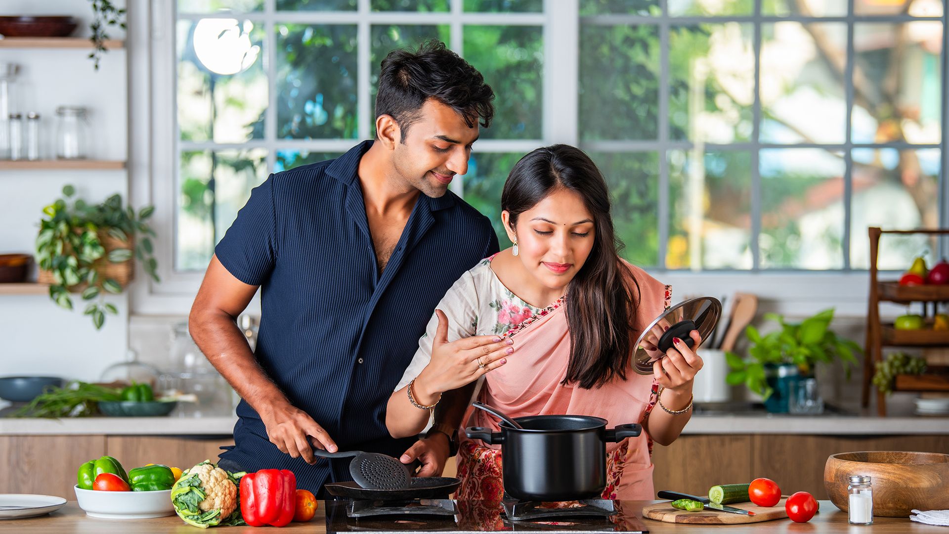 An Indian couple cooking in the kitchen