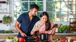 An Indian couple cooking in the kitchen