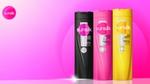 Three Sunsilk shampoo bottles in black, pink, and yellow, displayed against a vibrant pink gradient background with the Sunsilk logo in the top left corner.