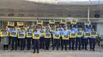 A group photo from HUL's factory site celebrating world safety week. The employees are holding placards that read 'All in for Safety.'