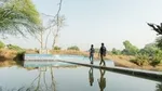 Men walking over water on a bridge