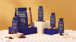Horlicks Protein powder and drink bottles displayed with chocolate, coffee, peanut, and vanilla ingredients