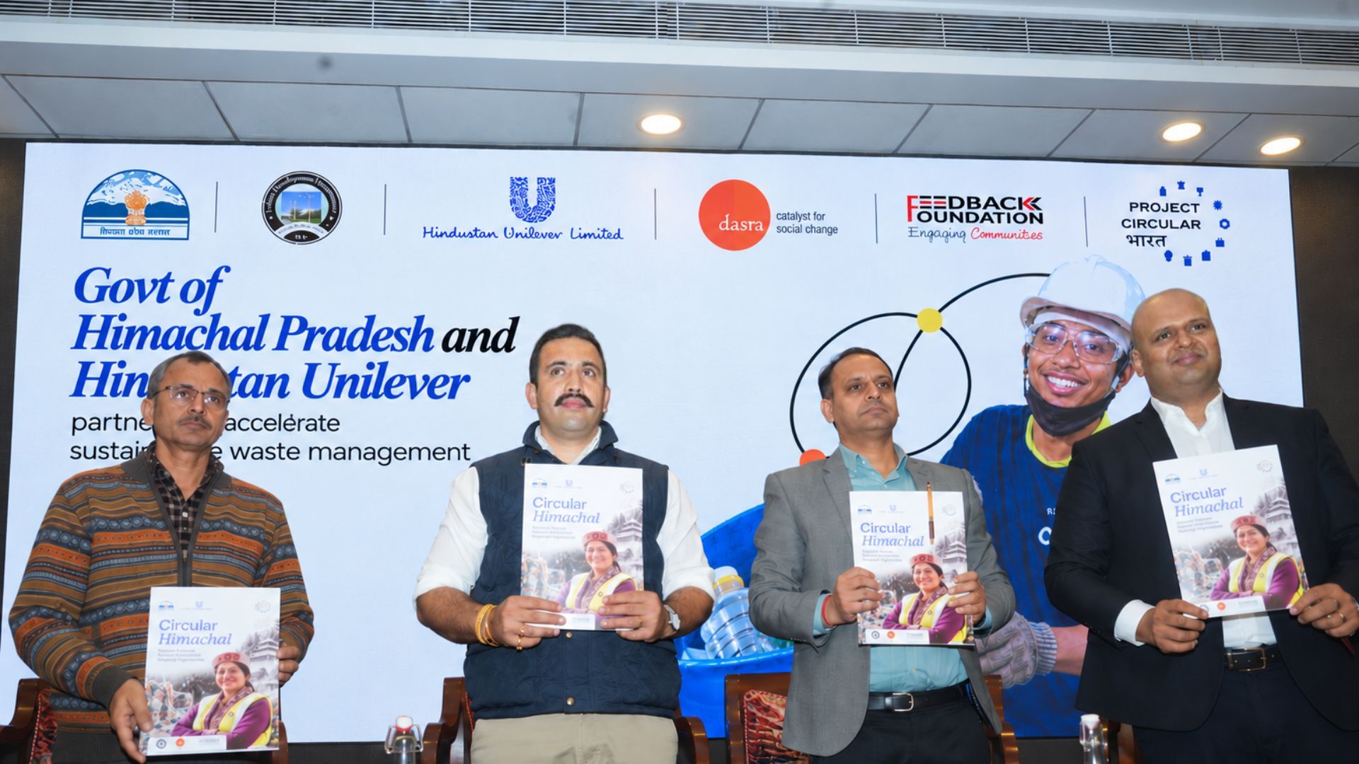 Four officials present the Project Circular Himachal publication at HUL's sustainable waste management event at Himachal Pradesh in collaboration with the Government.