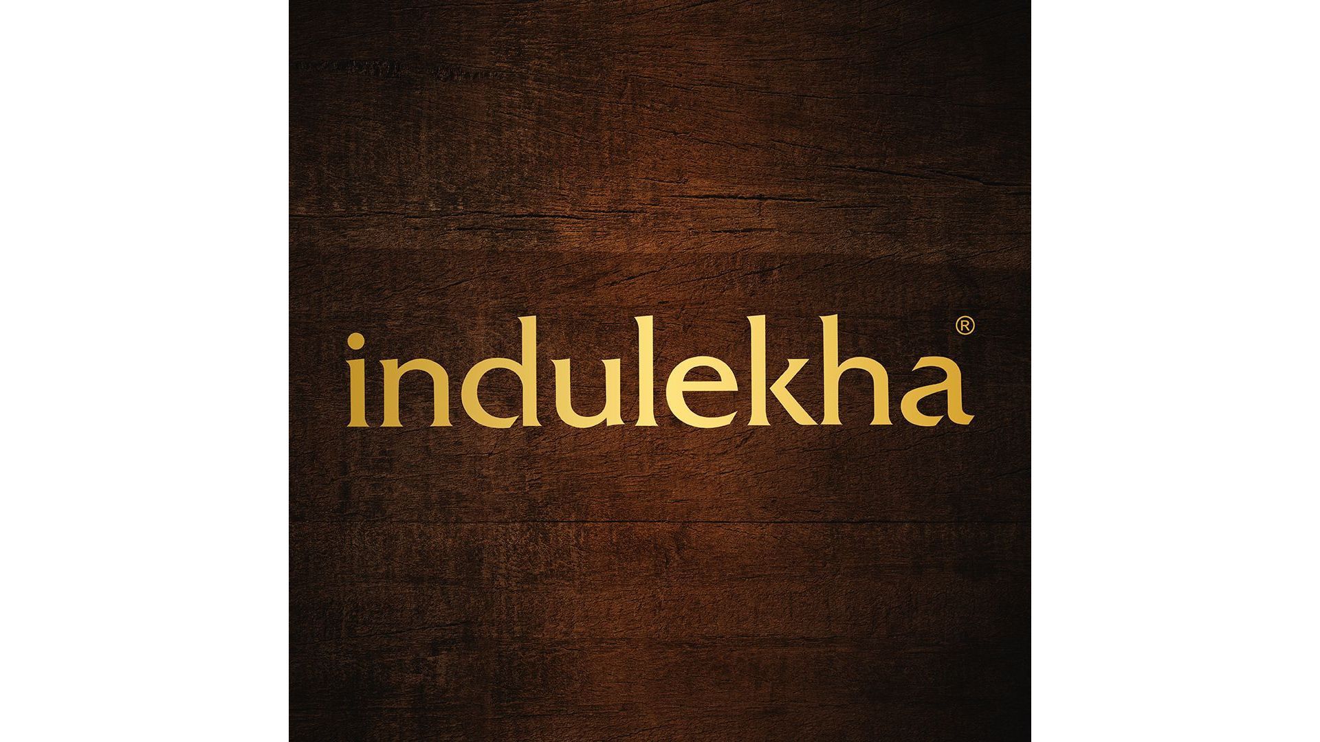 Indulekha logo with brown wood background