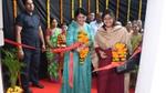 Indian women cutting a red collar on the first day of the sanitation community centre