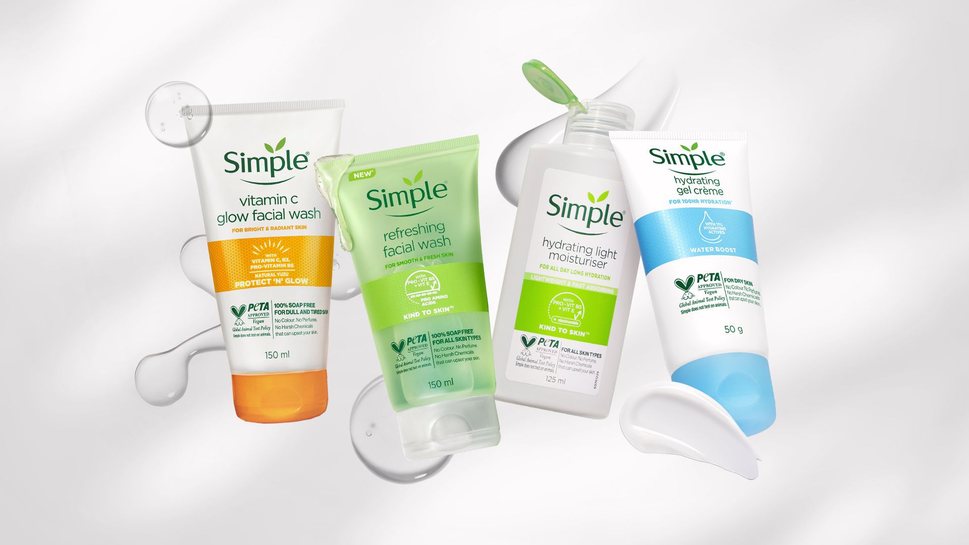 Four skincare products from the brand Simple displayed against a light background.