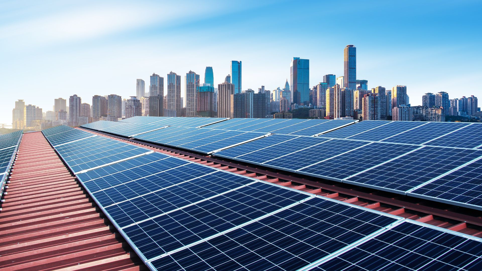 Solar panels on a building roof, with a view of a Chinese city skyline in the distance. 