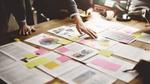 The image of a table with papers and reports