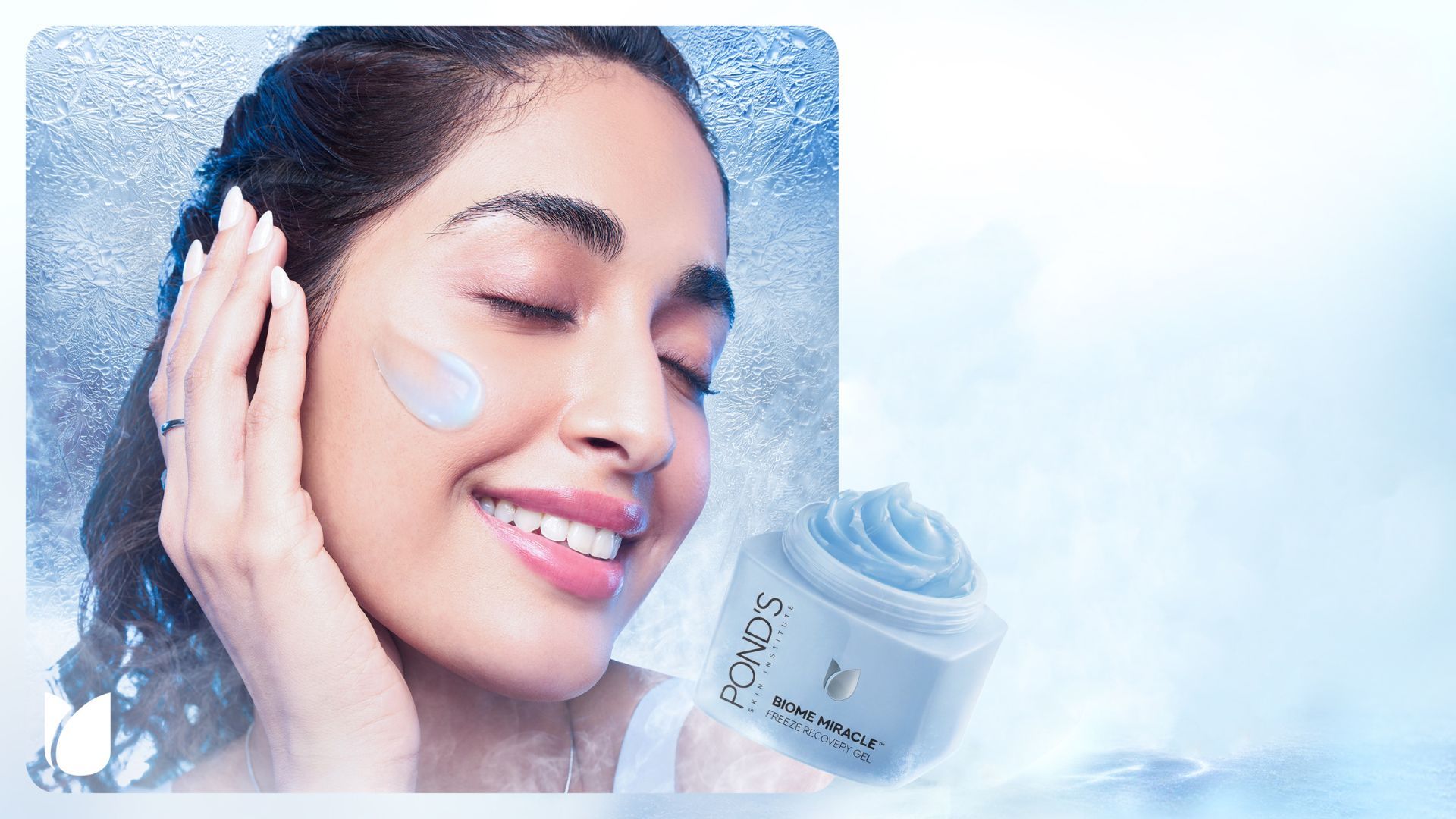 Smiling woman applies Pond’s Biome Miracle freeze recovery gel to her cheek beside the featured product jar.