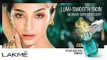 A model with dark hair and gold jewellery looks directly at the camera. The advert is for Lakme’s Lumi-Smooth AHA Serum.