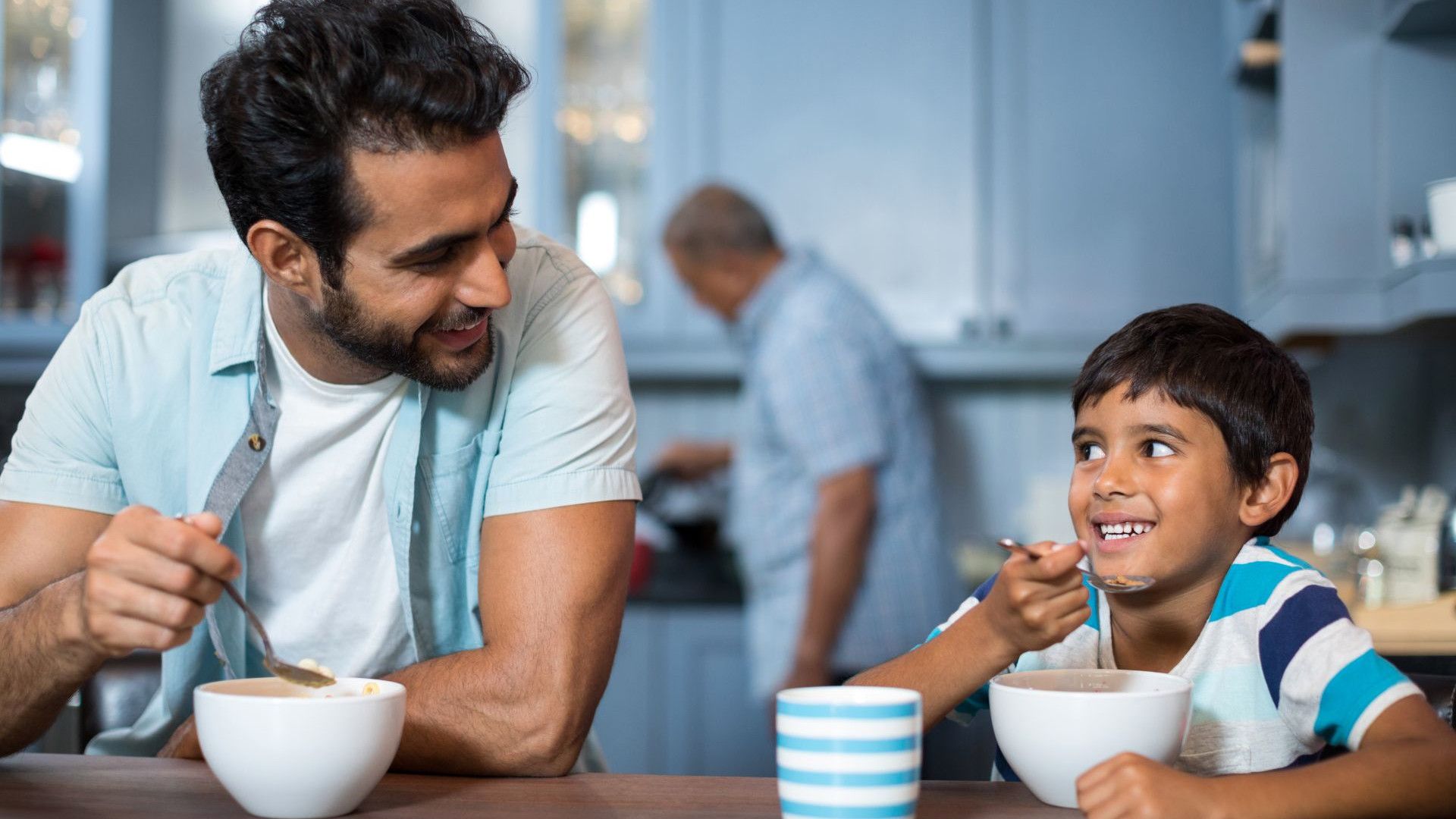 A man and a child have breakfast at home.