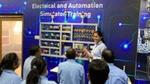 Factory team members in blue shirts receiving training in 4th Industrial Revolution technologies