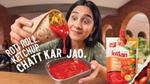 Woman pours Kissan tomato ketchup from a vegetable roti roll beside a ketchup pouch.