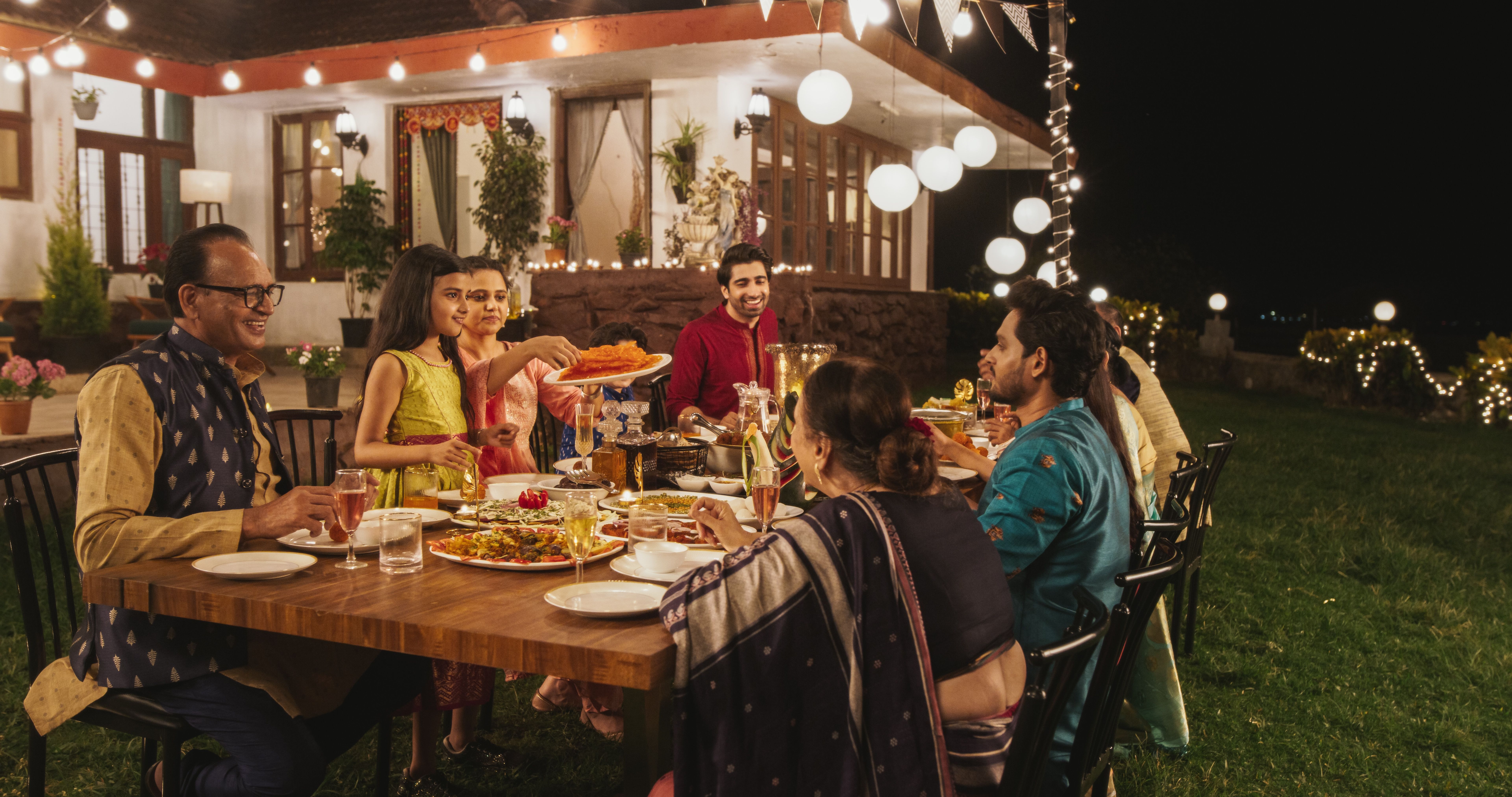 Indian family enjoying a meal outside