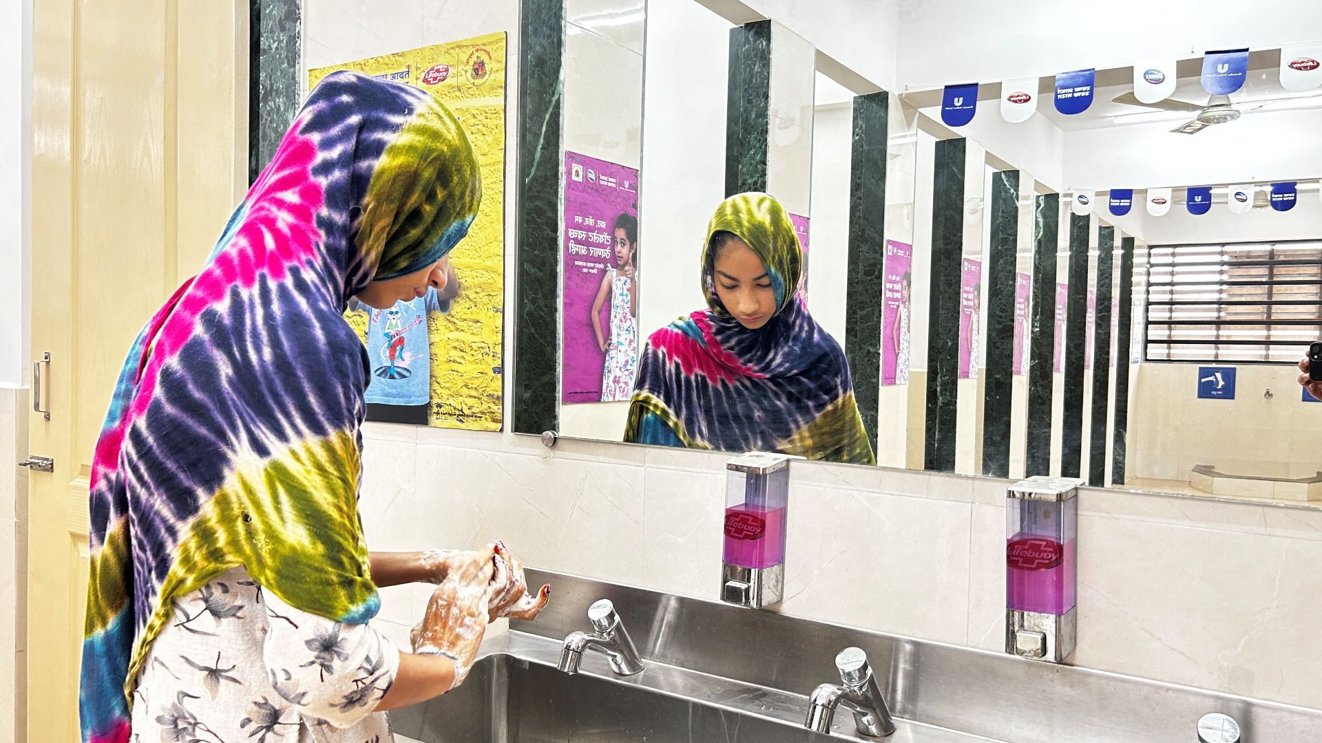 A woman at the handwashing station at the HUL Suvidha centre 