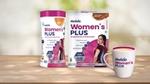 Two packs of Horlicks Women’s Plus packs in caramel and chocolate flavours featuring a woman with a spine illustration, along with a filled mug displayed on a wooden surface.