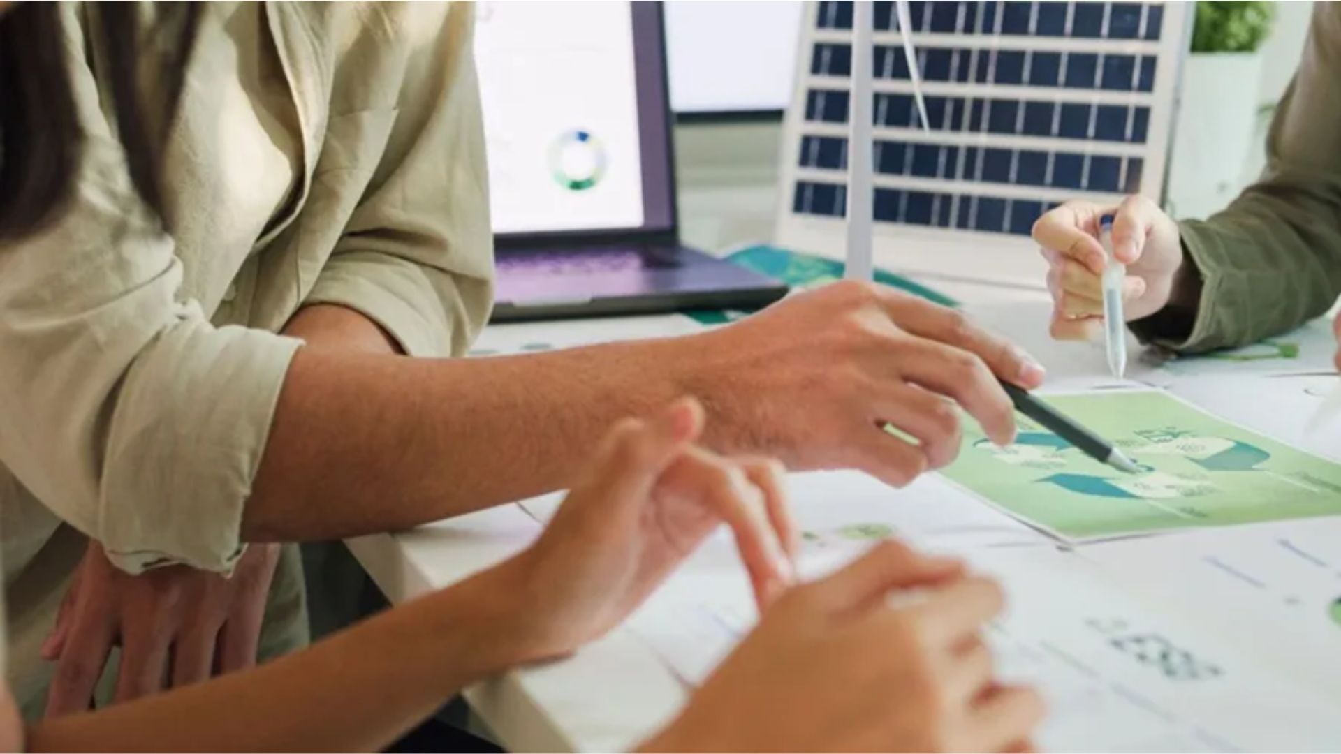 Image of three people working on a team project
