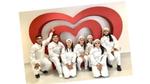 An image of happy HUL employees posing for a picture in front of a heart shaped structure.