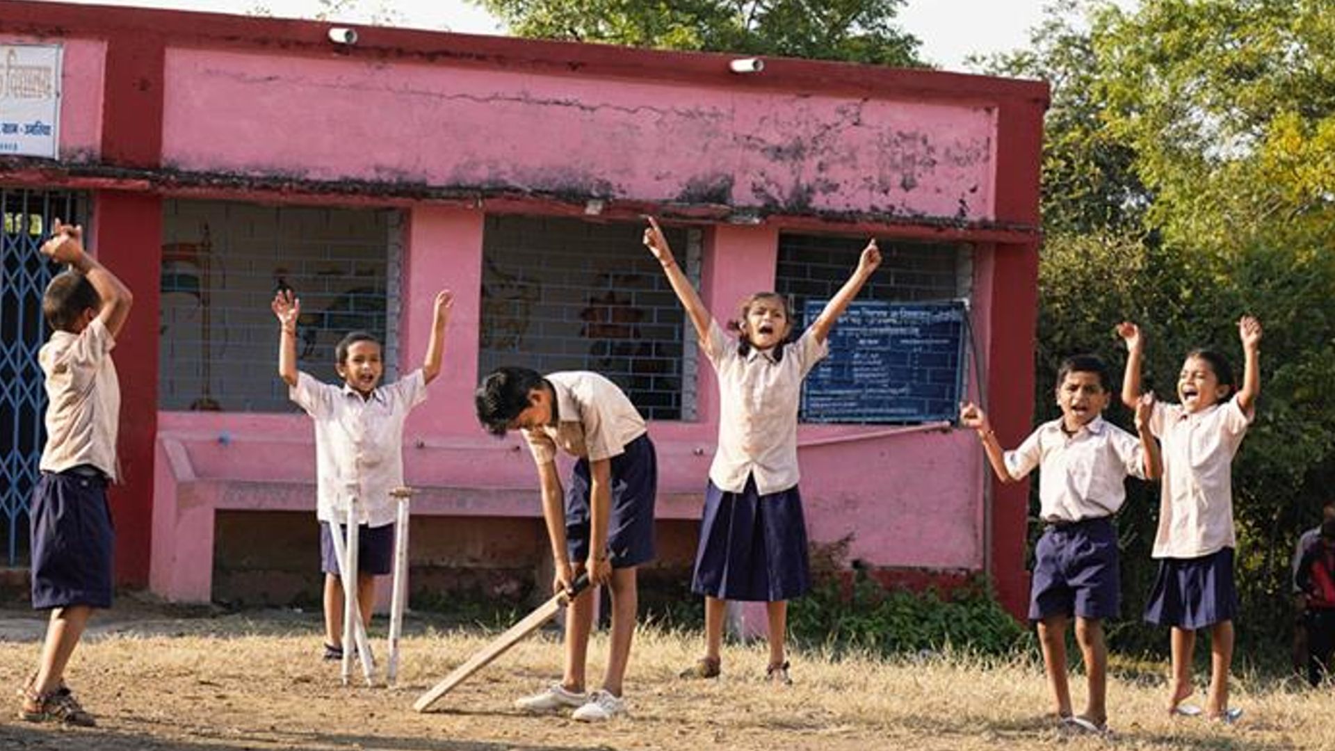 Village Kids playing cricket outdoors