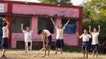 Village Kids playing cricket outdoors