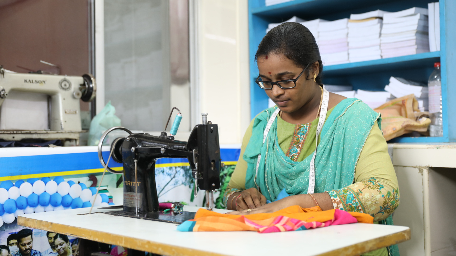 Image of a woman sewing on a machine