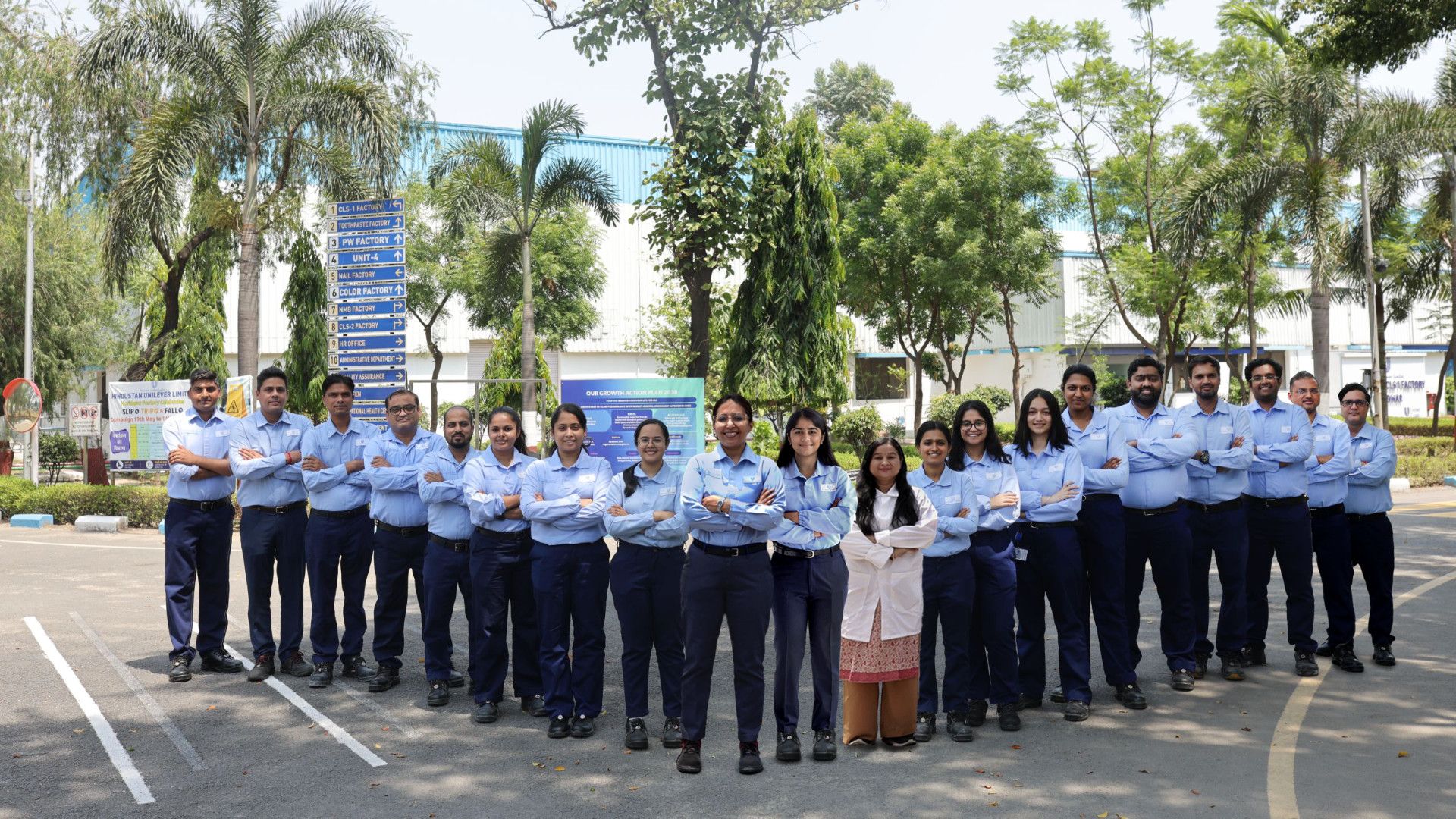 A team of employees standing together outdoors, posing for a group photo.