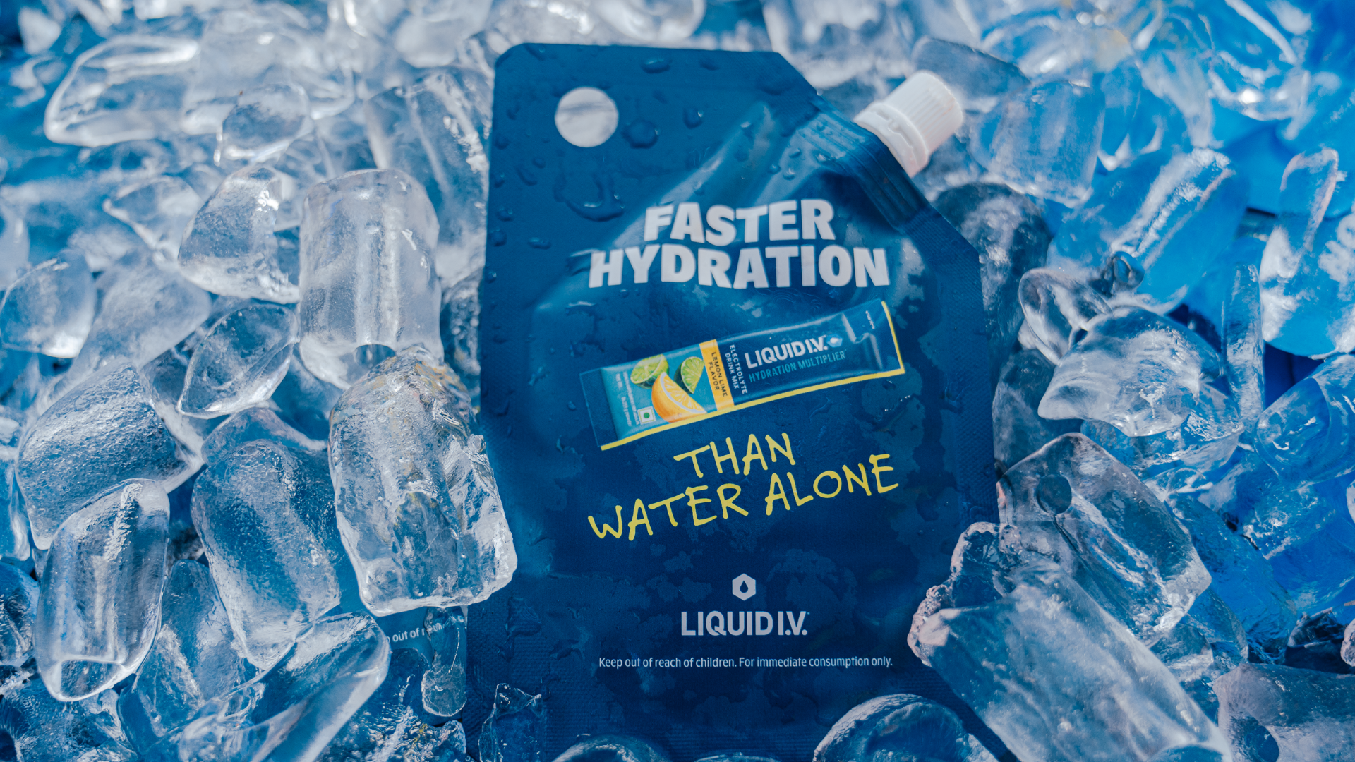 Liquid IV hydration packet surrounded by ice, promoting faster hydration than water alone. Blue and vibrant packaging on ice background.