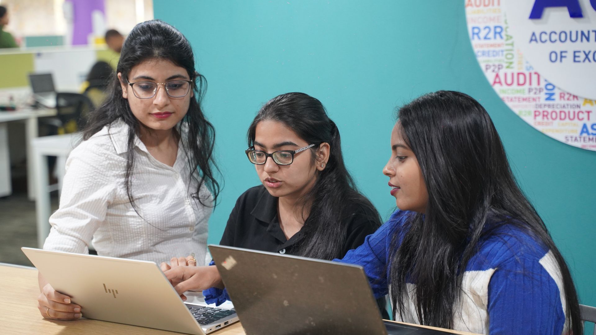 A group of women employees working on their laptops